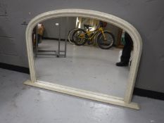 A white arched topped overmantel mirror