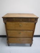 A 19th century oak four drawer chest with column supports
