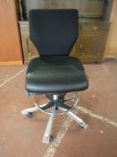 An adjustable swivel typists chair