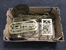A box of two brass trivets, chestnut roasters,