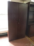 A double door office stationary cupboard in a mahogany finish