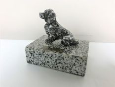 A chrome car mascot in the form of a spaniel,