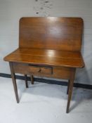 A Victorian mahogany turnover top table fitted a drawer