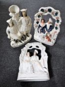 A pair of Staffordshire flat backed figures - Figures seated on a bench together with a