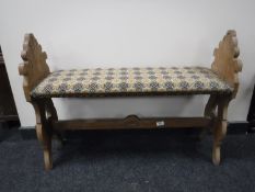 An early 20th century carved oak duet stool