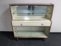 A mid 20th century melamine display cabinet