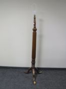 An antique mahogany standard lamp