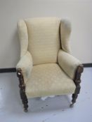 An early 20th century wingback armchair