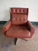 A twentieth century button leather armchair on chrome a five way chrome support