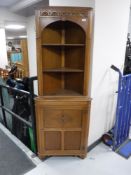 An oak corner display cabinet