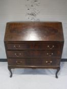 An inlaid mahogany writing bureau on cabriole legs