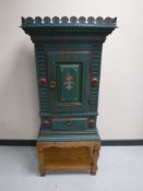 A 19th century hand painted cupboard on associated oak stand