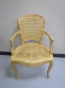 A cream and gilt bergere French armchair