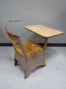 A mid 20th century child's school desk with chair