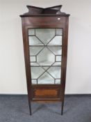 A Victorian mahogany corner cabinet with astral glazed door