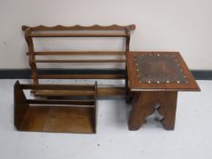 An Arts & Crafts walnut leather topped occasional table together with a book trough and wall rack