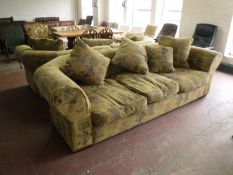 A pair of large three seater settees with loose cushions upholstered in a classical print