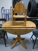 A pine drop leaf pedestal kitchen table,