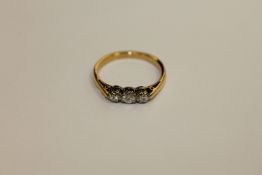 An 18ct gold three stone diamond ring