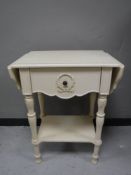 A white painted flap sided table,