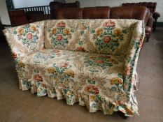 An early twentieth century two seater settee upholstered in floral fabric