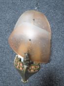An Art Deco brass and coloured glass wall light in the form of the bow of a ship,