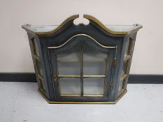 A painted glazed door wall cabinet