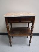 An antique mahogany two tier marble topped side table