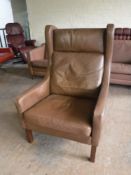 A twentieth century brown leather wingback armchair
