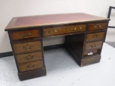 A Victorian mahogany twin pedestal writing desk with a red inset leather panel