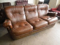 A brown button leather three seater settee