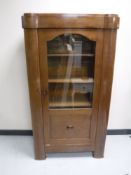 An early 20th century continental mahogany glazed door cabinet
