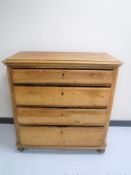 A 19th century pine four drawer chest on bun feet