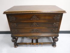 A 20th century oak three drawer chest on bulbous legs