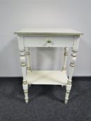 An antique cream and gilt painted hall table