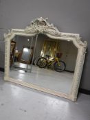 A white Victorian style overmantel mirror