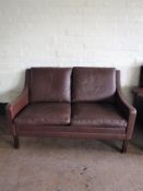A twentieth century brown leather two seater settee,