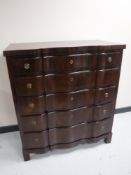 A continental mahogany serpentine fronted five drawer chest