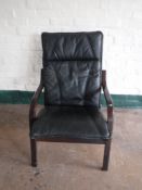 A late twentieth century wood framed black leather armchair