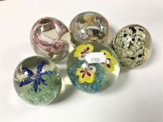 Five glass paperweights
