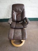 A brown leather Stressless adjustable armchair with stool CONDITION REPORT: Typical