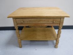 A blonde oak coffee table fitted a drawer
