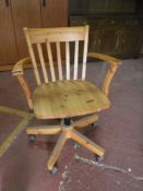 A pine swivel office armchair