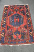 An Iranian Hamadan rug on blue ground