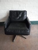 A twentieth century black leather Danish swivel armchair on chrome base