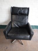 A twentieth century black leather Danish wingback armchair on chrome base