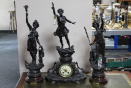 A three piece French spelter clock garniture