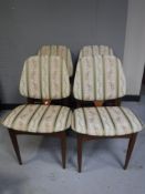 A set of four mid twentieth century teak dining chairs,