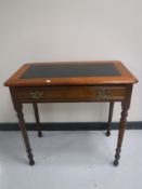 A Victorian mahogany writing table fitted a drawer