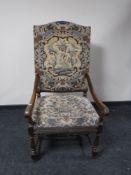 A continental oak scroll arm armchair